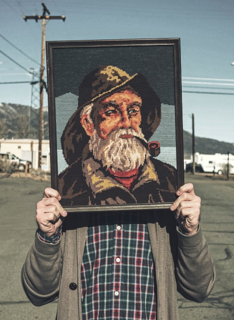 Person holding painting of a sailor