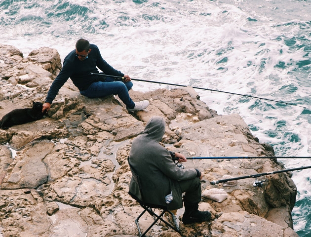 People on cliff fishing